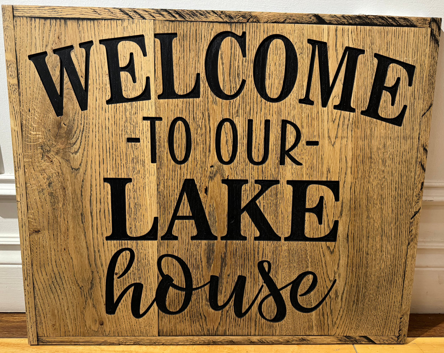 Wooden sign that says welcome to our lake house