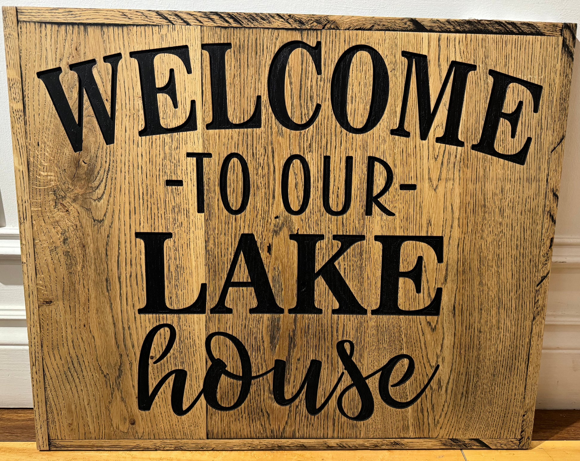 Wooden sign that says welcome to our lake house